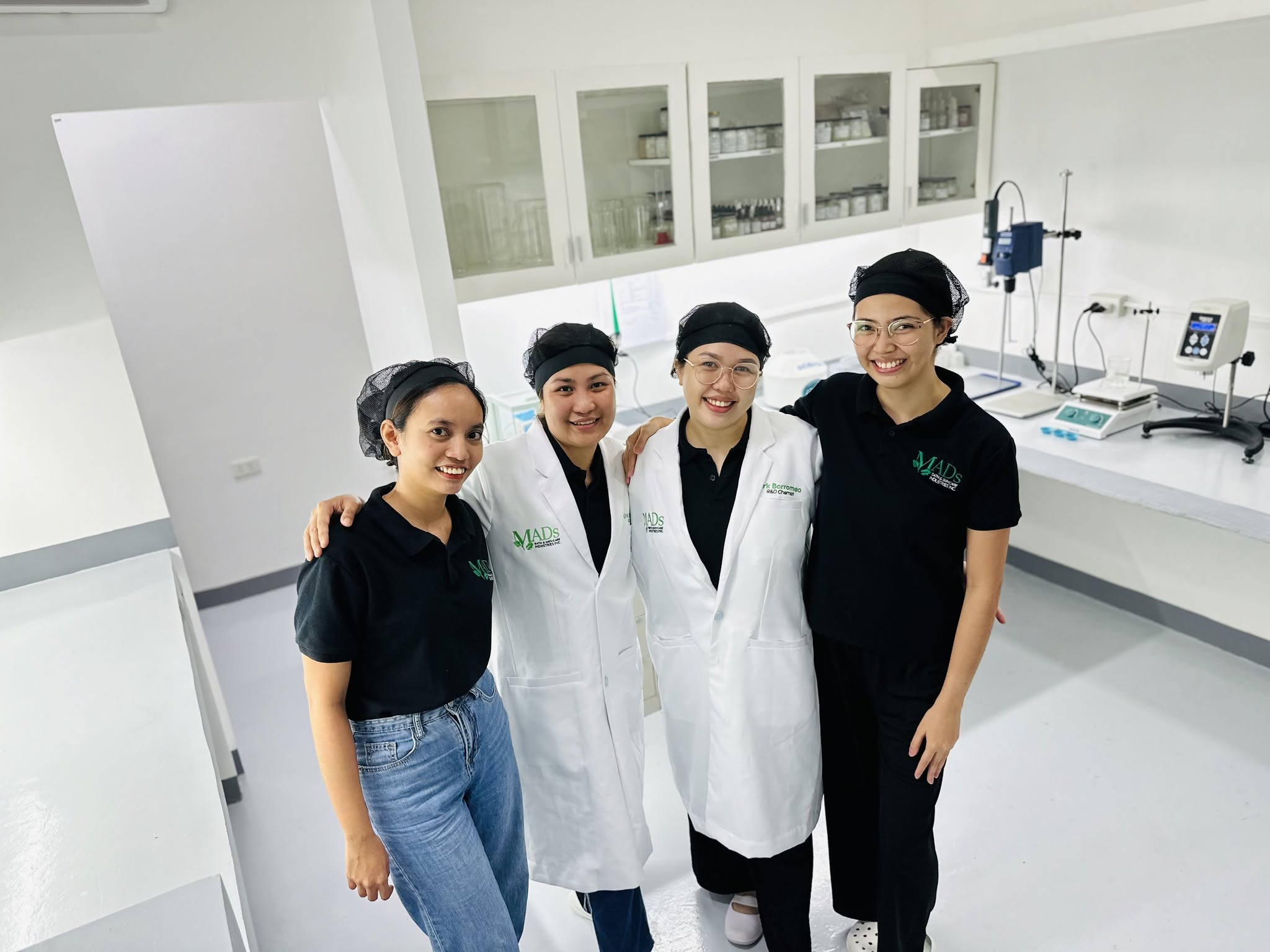 MADS team in the laboratory, with formulation equipment and ingredient cabinets